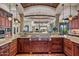 Open kitchen with large island, gas cooktop, and granite countertops at 10612 E Winter Sun Dr, Scottsdale, AZ 85262