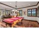 Game room with pool table and adjacent sitting area with wood flooring at 10612 E Winter Sun Dr, Scottsdale, AZ 85262