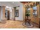 Grand hallway with tile flooring, ornate columns, and access to other rooms at 10612 E Winter Sun Dr, Scottsdale, AZ 85262