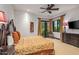 Comfortable bedroom with private access to a patio and a large TV at 10612 E Winter Sun Dr, Scottsdale, AZ 85262