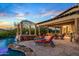 Elegant patio with a spa, seating, and views of the pool at 10612 E Winter Sun Dr, Scottsdale, AZ 85262