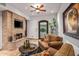 Cozy sitting area with fireplace, comfortable seating, and a large framed print at 10612 E Winter Sun Dr, Scottsdale, AZ 85262