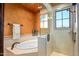 Bathroom with soaking tub, shower, and tiled walls at 10612 E Winter Sun Dr, Scottsdale, AZ 85262