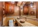 Elegant powder room with granite vanity and decorative mirror at 10612 E Winter Sun Dr, Scottsdale, AZ 85262