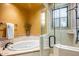 Spa-like bathroom with soaking tub, shower, and tiled walls at 10612 E Winter Sun Dr, Scottsdale, AZ 85262