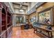 Spacious home office with built-in bookcases and hardwood floors at 10612 E Winter Sun Dr, Scottsdale, AZ 85262
