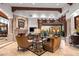 Living room with fireplace, access to backyard, and luxurious furnishings at 10612 E Winter Sun Dr, Scottsdale, AZ 85262