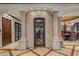 Impressive wine cellar with extensive wooden racking and a glass-paned door at 10612 E Winter Sun Dr, Scottsdale, AZ 85262