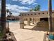 Covered patio area with tables and chairs overlooking the pool at 648 Hawks Eye Dr # 648, Apache Junction, AZ 85119