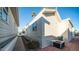 Side view of a tan mobile home with AC unit and landscaping at 648 Hawks Eye Dr # 648, Apache Junction, AZ 85119