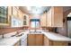 Clean and bright kitchen with white appliances and wood cabinets at 648 Hawks Eye Dr # 648, Apache Junction, AZ 85119