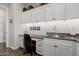 Built-in workspace with white cabinets and grey countertop at 35564 N Sunset Trl, San Tan Valley, AZ 85140