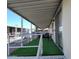 Covered patio provides shaded outdoor space with artificial turf at 9333 E University Dr # 89, Mesa, AZ 85207