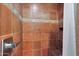 Walk-in shower with tiled walls and built-in seat at 2002 E Myrtle Ave, Phoenix, AZ 85020