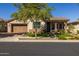 Single-story home with a two-car garage and landscaped yard at 20960 W Mariposa St, Buckeye, AZ 85396