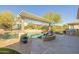 Relaxing pool area with a pergola and fire pit feature at 20960 W Mariposa St, Buckeye, AZ 85396