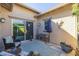 Private patio with seating and adjacent to a sliding glass door at 20960 W Mariposa St, Buckeye, AZ 85396