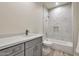 Bathroom with gray vanity, marble shower, and soaking tub at 9121 W Debbie Ln, Arizona City, AZ 85123