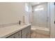 Bathroom with single vanity, marble shower/tub combo, and gray cabinets at 9121 W Debbie Ln, Arizona City, AZ 85123