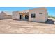Rear view of house with patio and desert landscaping at 9121 W Debbie Ln, Arizona City, AZ 85123
