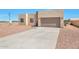 New construction home with attached garage and gravel driveway at 9121 W Debbie Ln, Arizona City, AZ 85123