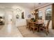 Bright dining room with a large table and access to the entryway at 13431 W Los Bancos Dr, Sun City West, AZ 85375