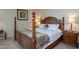 Main bedroom with a large wooden bed frame and nightstands at 19466 N Star Ridge Dr, Sun City West, AZ 85375