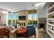 Spacious living room with a fireplace, large windows, and scenic views at 10755 E Stoney Ln, Scottsdale, AZ 85262