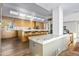Modern kitchen with marble countertops, wood cabinetry, and a large island at 10755 E Stoney Ln, Scottsdale, AZ 85262