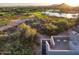 Stunning aerial view of property, showcasing golf course and mountain views at 10755 E Stoney Ln, Scottsdale, AZ 85262