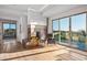 Light-filled living area with a contemporary fireplace and access to a patio at 10755 E Stoney Ln, Scottsdale, AZ 85262