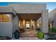 Modern covered entryway with seating and landscaping at 10755 E Stoney Ln, Scottsdale, AZ 85262