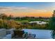 Stunning infinity pool overlooking a golf course and mountain views at sunset at 10755 E Stoney Ln, Scottsdale, AZ 85262