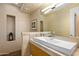 Modern bathroom with a sleek vanity, large mirror, and recessed shelving at 10755 E Stoney Ln, Scottsdale, AZ 85262