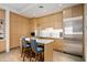 Modern kitchenette with stainless steel appliances and breakfast bar at 10755 E Stoney Ln, Scottsdale, AZ 85262