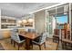 Elegant dining room featuring a large wood table, modern chandelier, and access to a patio at 10755 E Stoney Ln, Scottsdale, AZ 85262