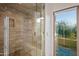 Spacious shower with glass enclosure and built-in seat at 10755 E Stoney Ln, Scottsdale, AZ 85262