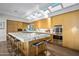 Spacious kitchen with large marble island, skylights, and stainless steel appliances at 10755 E Stoney Ln, Scottsdale, AZ 85262