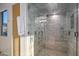 Spacious walk-in shower with multiple shower heads and a built-in seat at 10755 E Stoney Ln, Scottsdale, AZ 85262