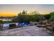 Luxury infinity pool with fire pit and scenic sunset views at 10755 E Stoney Ln, Scottsdale, AZ 85262
