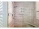 Walk-in shower with glass enclosure and built-in seat at 10755 E Stoney Ln, Scottsdale, AZ 85262