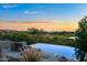 Infinity pool with sunset views over the golf course at 10755 E Stoney Ln, Scottsdale, AZ 85262