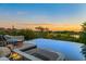 Luxury infinity pool with spa and fire pit, overlooking a stunning sunset view at 10755 E Stoney Ln, Scottsdale, AZ 85262