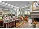 Bright living room with fireplace and large windows showcasing scenic views at 10755 E Stoney Ln, Scottsdale, AZ 85262