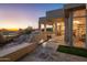 Outdoor patio area with sunset views, stone flooring and a built in bench at 10755 E Stoney Ln, Scottsdale, AZ 85262