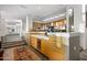 Modern kitchen with a large island, wine cooler, and marble countertops at 10755 E Stoney Ln, Scottsdale, AZ 85262