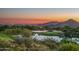 Scenic golf course view at sunset with city lights at 10755 E Stoney Ln, Scottsdale, AZ 85262