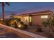 Attractive backyard at dusk with fire pit, patio furniture, and landscaping at 2607 E San Simeon Dr, Casa Grande, AZ 85194