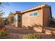 Home exterior showcasing a large window and desert landscaping at 2607 E San Simeon Dr, Casa Grande, AZ 85194