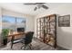 Home office with built-in shelving and large window at 16053 N 26Th Cir, Phoenix, AZ 85023